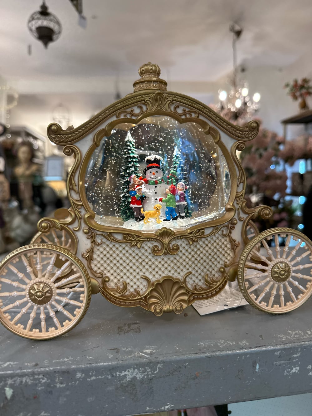 Carrosse décoratif lumineux et musical style conte de fées, boule à neige de Noël avec scène hivernale, bonhomme de neige et enfants sous les flocons, décoration féérique ivoire et or