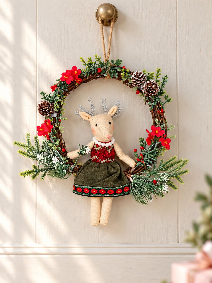 Couronne de Noël avec souris suspendue à une porte ivoire dans une lumière naturelle douce.