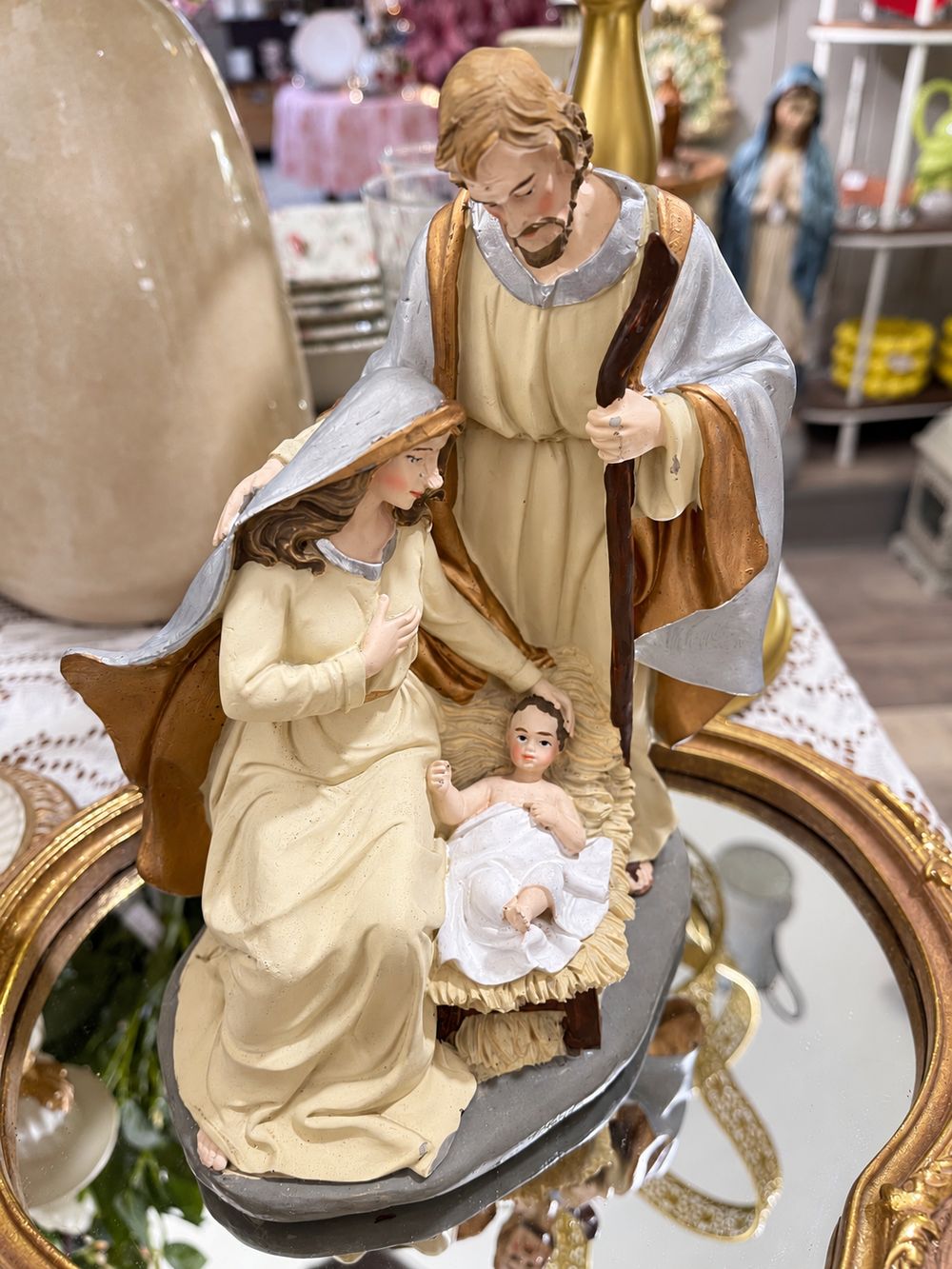 Vue de face de la crèche de Noël en résine, avec Marie et Joseph autour de l’enfant Jésus.