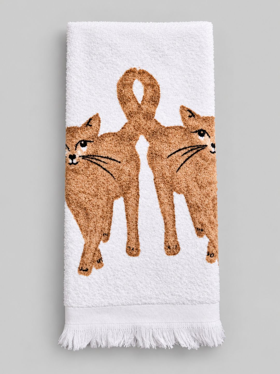 Essuie-main blanc en coton à motifs de chats beiges, présenté plié sur fond gris clair.