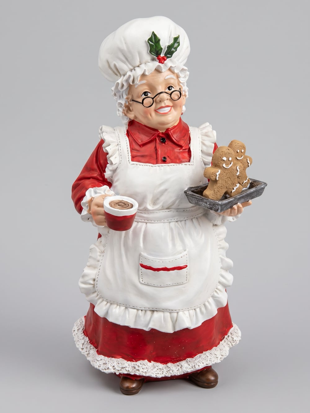 Figurine décorative de 30 cm représentant la Mère Noël en tenue de pâtissière rouge et blanche, tenant une tasse et un biscuit pain d’épices, style vintage et féérique
