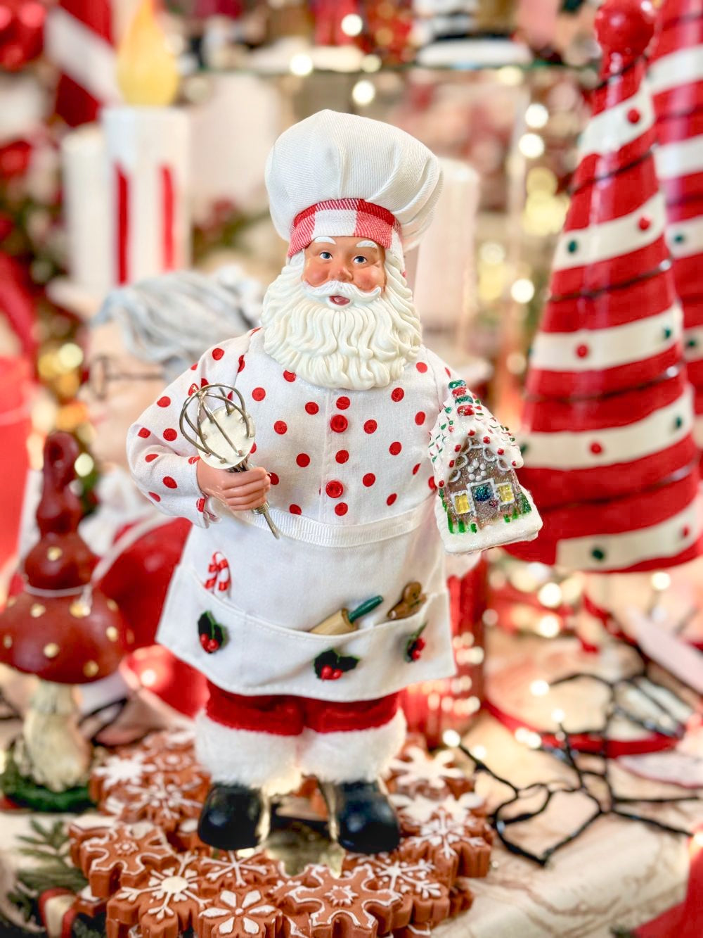 Figurine Père Noël Pâtissier 28 cm en rouge et blanc, tenant un fouet et une maison en pain d’épices, style shabby chic et féérique pour décoration de Noël