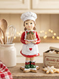 Figurine Petite Cuisinière de Noël rouge, blanche et verte tenant un gâteau, décoration rétro et gourmande pour la cuisine