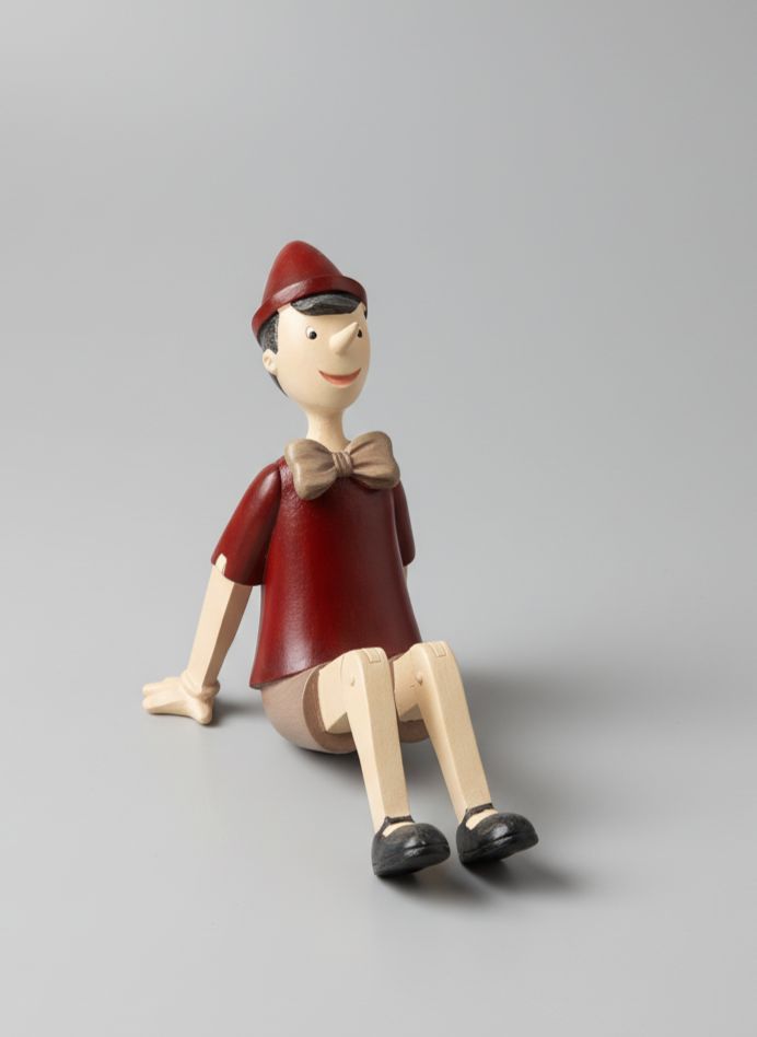 Figurine Pinocchio assis rouge beige marron style décoration romantique et vintage