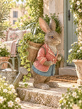 Grand lapin décoratif brun vêtu de rose et bleu avec panier dans le dos, style Alice romantique et décoration poétique de Pâques