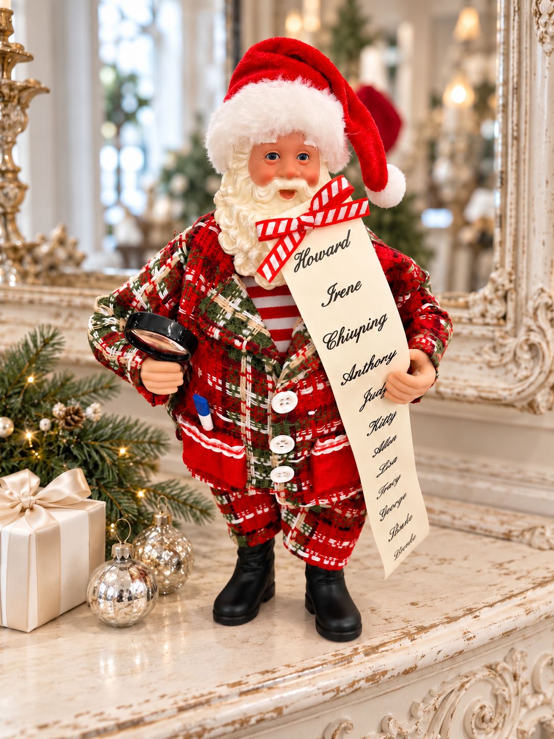 Figurine Père Noël avec sa liste sur une console patinée, près de boules argentées et d’un cadeau ivoire.