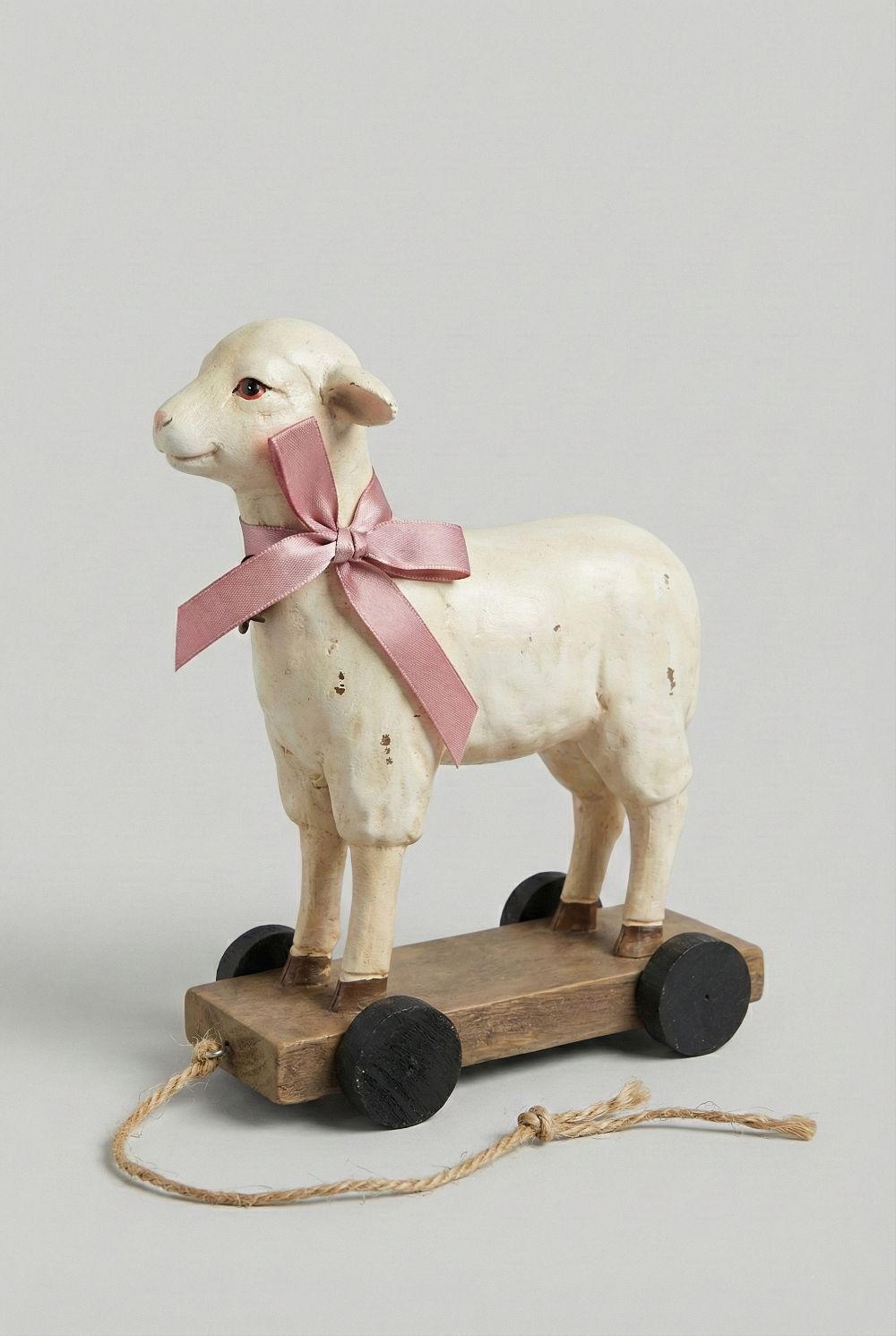 Objet décoratif ancien mouton blanc patiné avec ruban rose, monté sur roulettes, style shabby chic romantique et ambiance poétique
