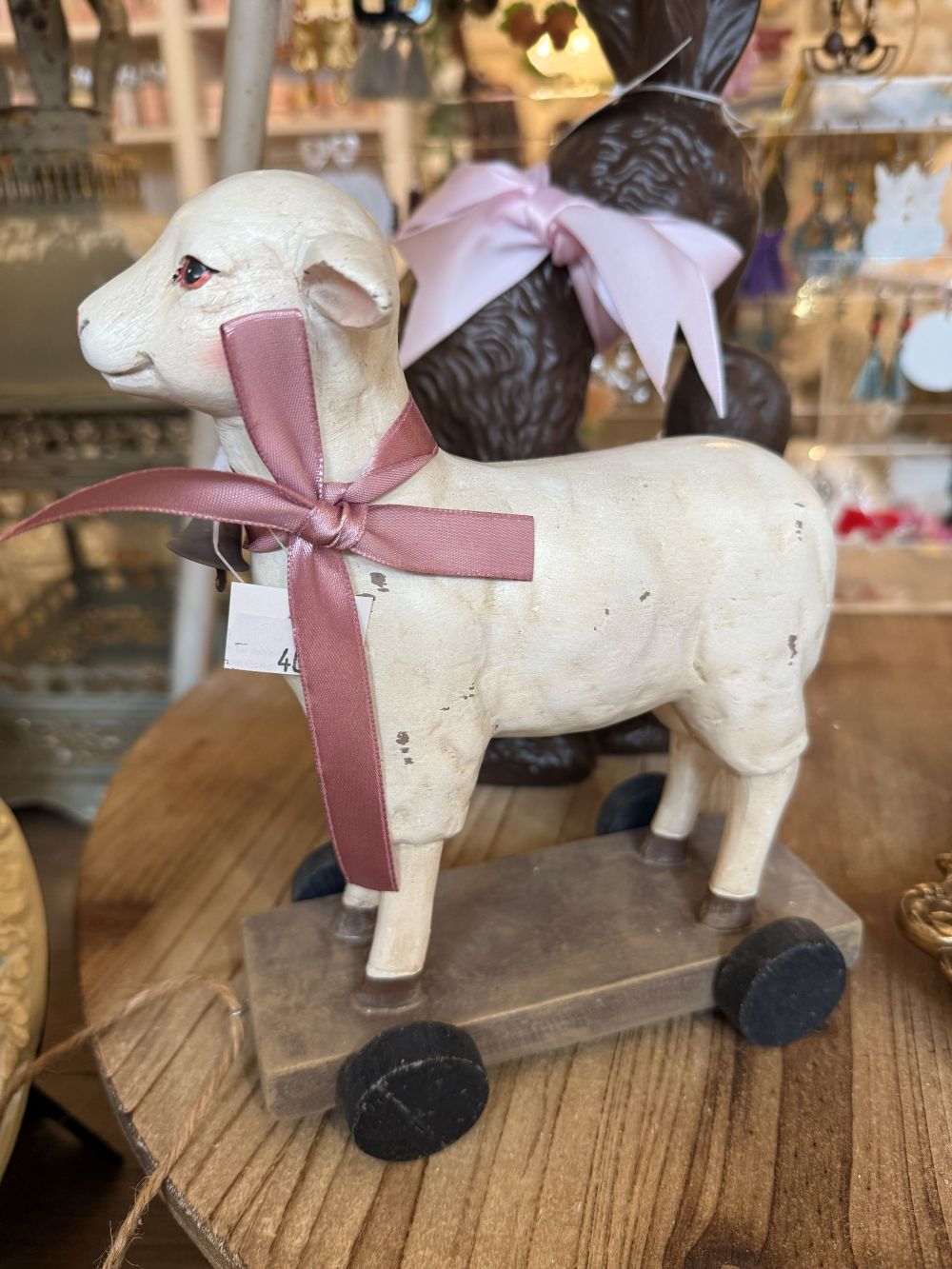 Objet décoratif ancien mouton blanc patiné avec ruban rose, monté sur roulettes, style shabby chic romantique et ambiance poétique