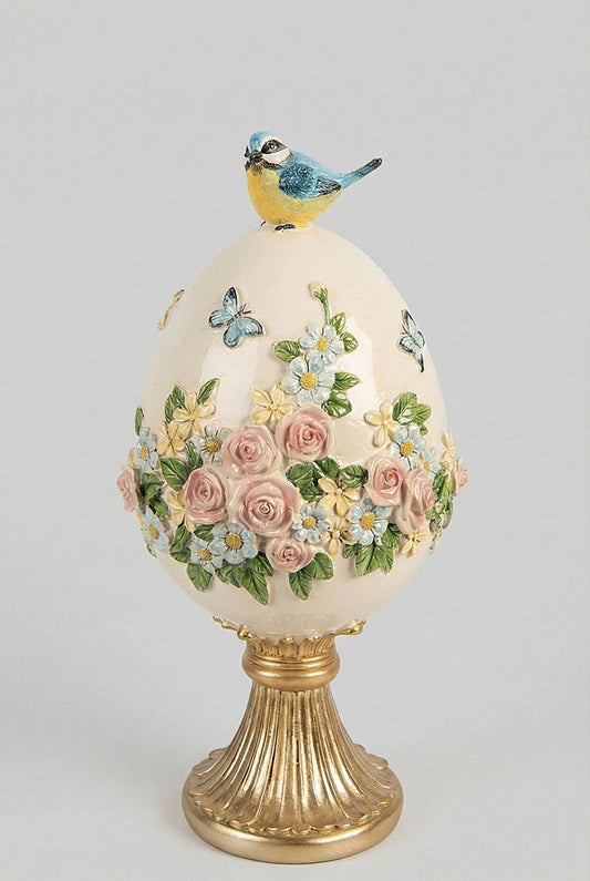 Œuf décoratif romantique blanc crème avec fleurs roses et bleues en relief, oiseau bleu sur le dessus et pied doré, décoration shabby chic et poétique.