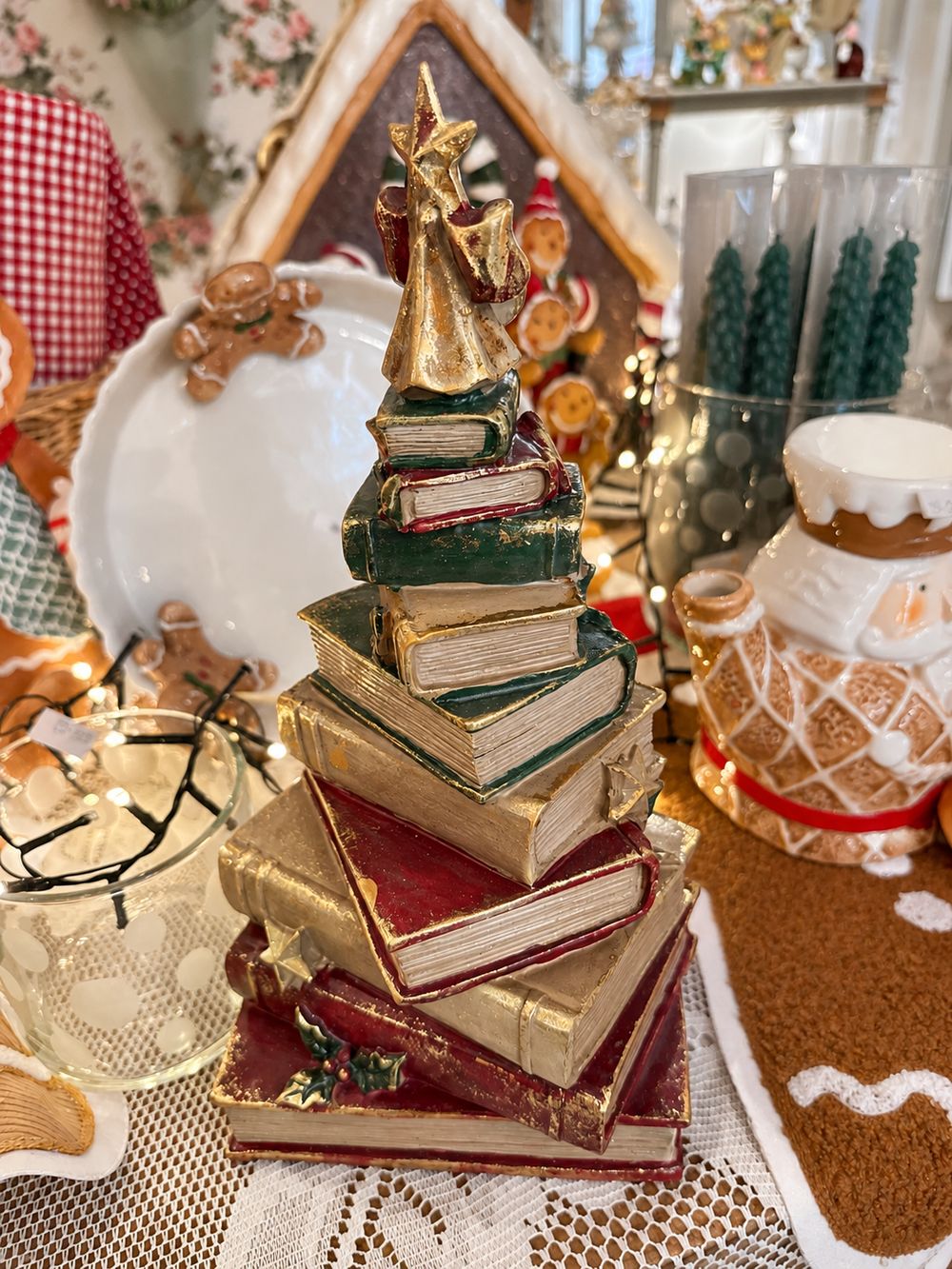 Figurine sapin de Noël composée de livres empilés rouges, verts et dorés, surmontée d’une étoile, décoration vintage et féérique à poser.